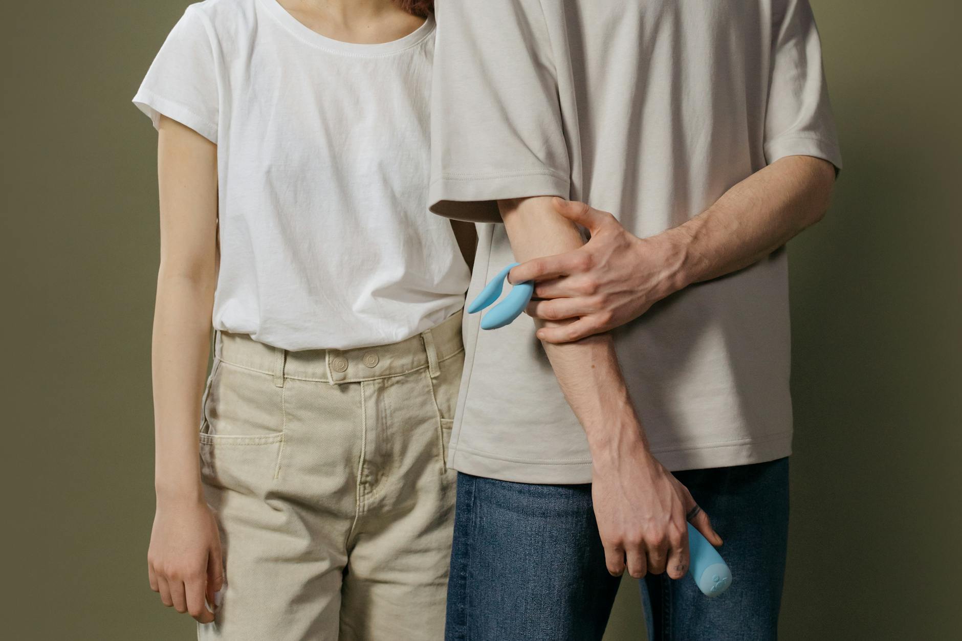 A young couple standing together indoors, holding intimacy and connection